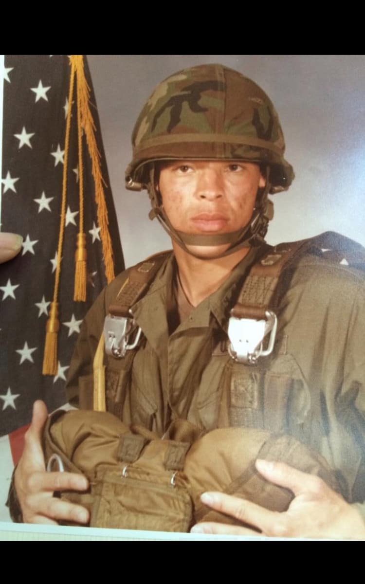 Bobby Henry in full Army paratrooper gear with American flag